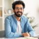 successful-freelancer-happy-millennial-indian-man-sitting-desk-with-laptop (1)
